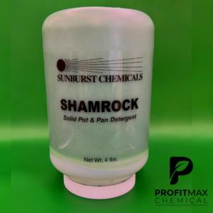 An image graphic of the Shamrock chemical that is contained in a green jar with a white lid. The jar presents black text atop a clear label. The label presents the text in a vertical alignment. The black text attached to the label has the word Sunburst placed on top of the jar with their logo sitting right above that. The Sunburst logo is a black circle representing a sun with black lines representing rays that shoot to the right which covers the word, Sunburst. Below that is the chemical name, Shamrock, that sits right above the description. The description is a Solid Pot & Pan Detergent. Below, is the Net Wt close to the white cap. The text Net Wt in black text is followed by 4 lbs. To the right of the jar at the bottom of the image is the ProfitMax P logo in white text. To the right, in black text is ProfitMax atop of the word Chemical in black text. The image graphic is placed in front of a slimy green background.